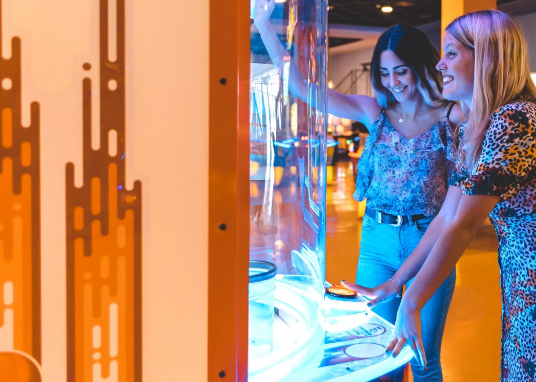 sideways-happy-women-playing-arcade-game